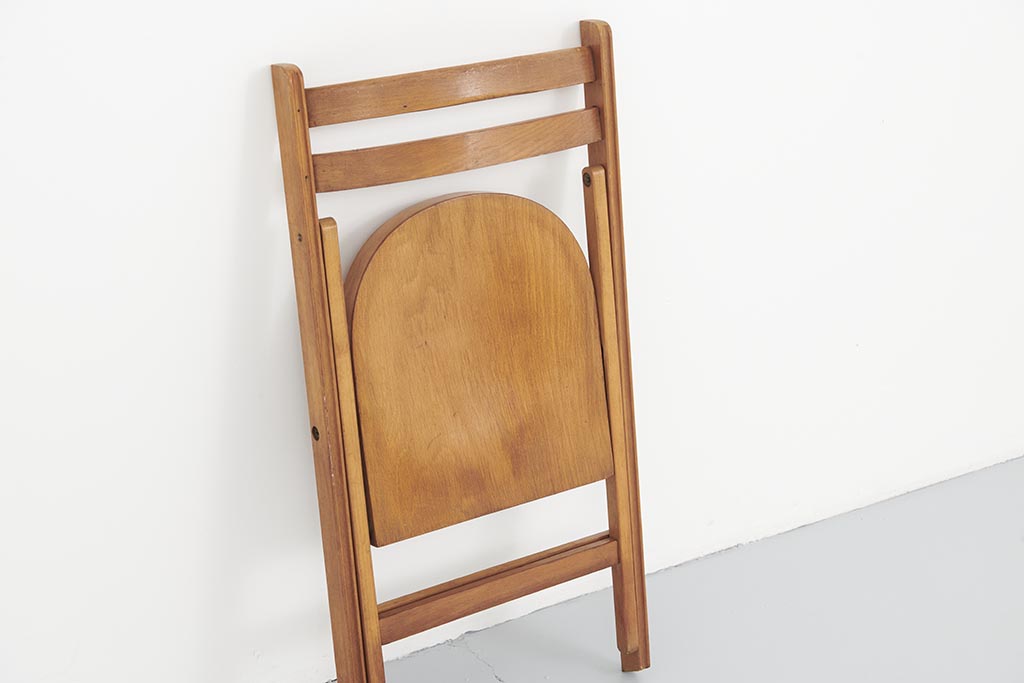 Vintage folding wooden chair with half-moon seat
