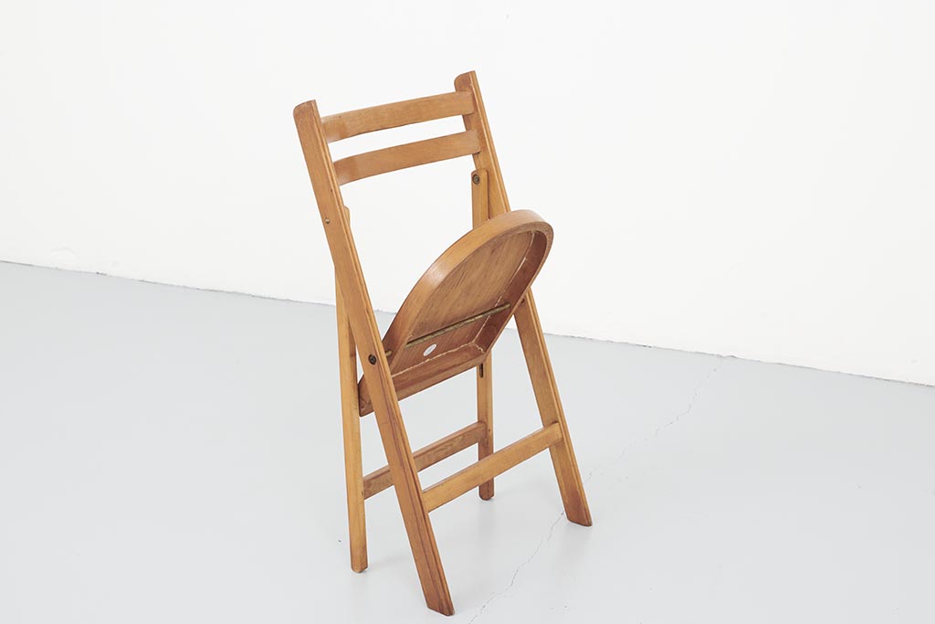 Vintage folding wooden chair with half-moon seat