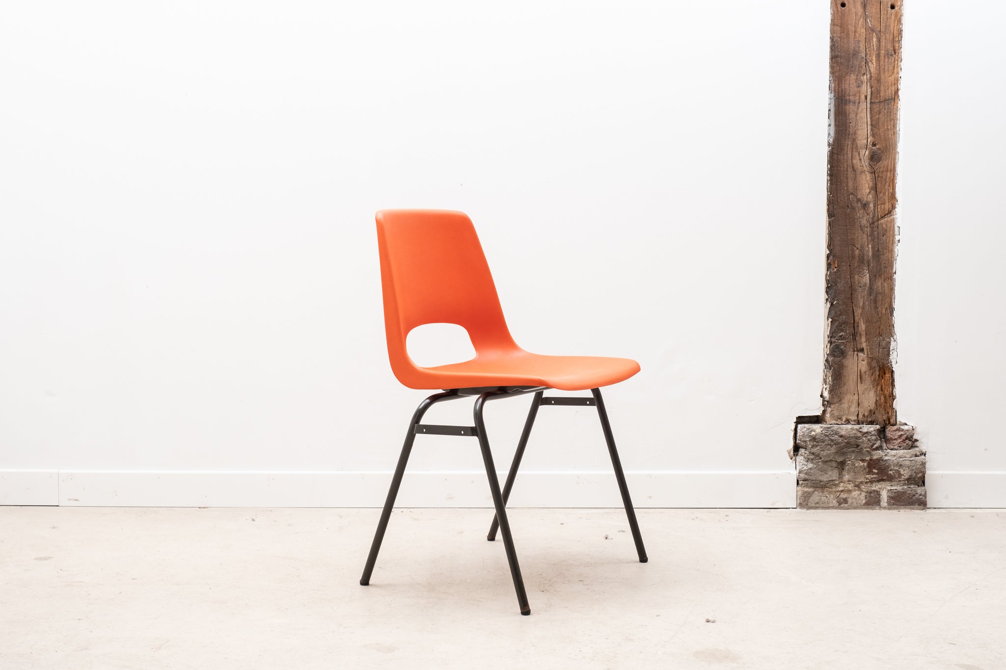 Stackable orange plastic patio chair