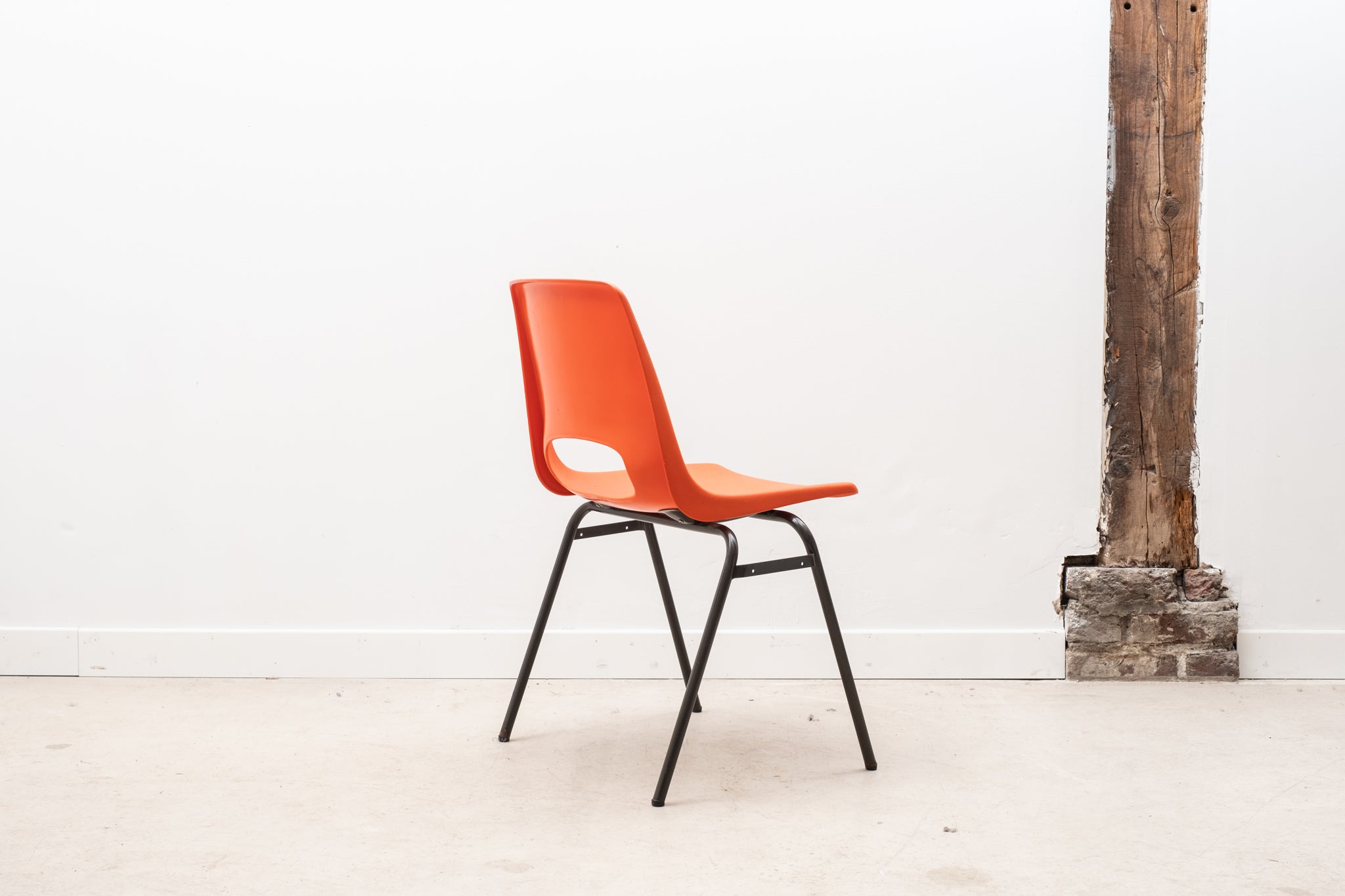 Stackable orange plastic patio chair