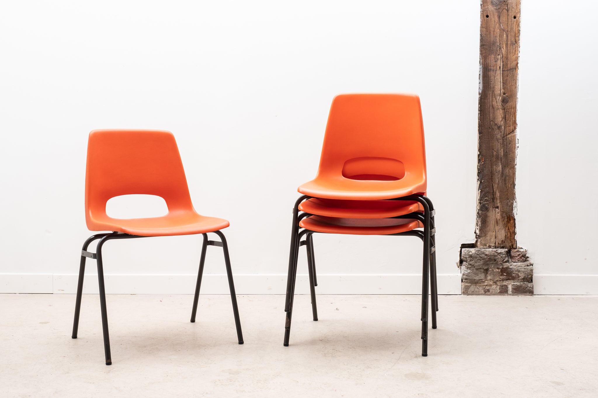 Stackable orange plastic patio chair