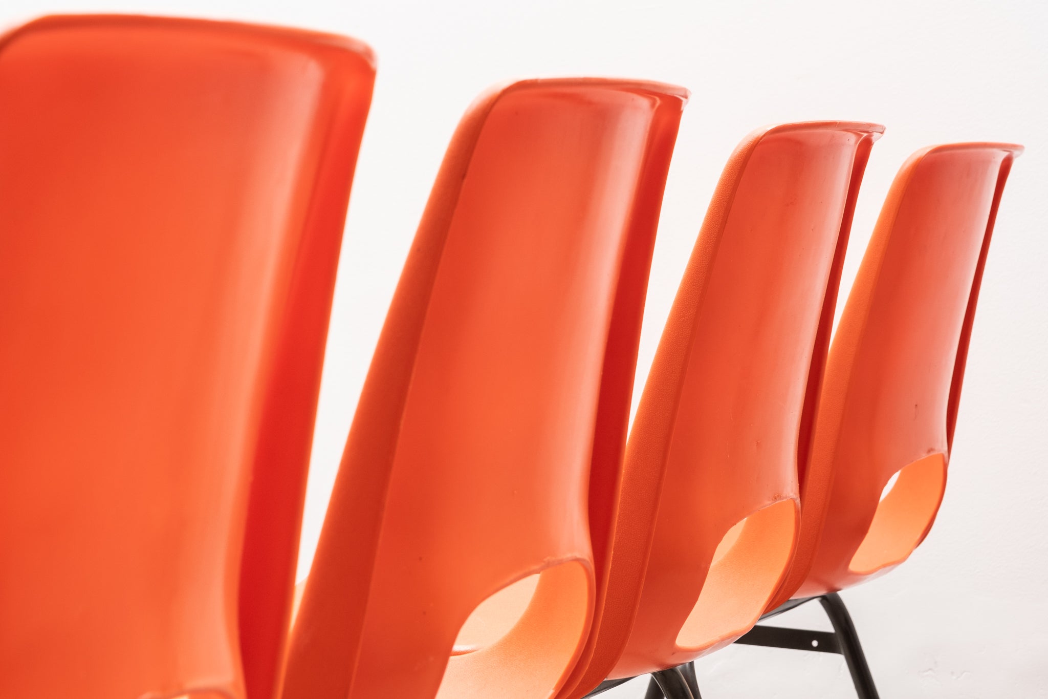 Stackable orange plastic patio chair