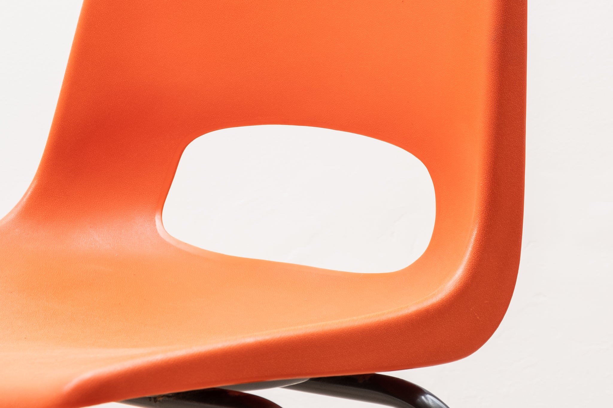 Stackable orange plastic patio chair